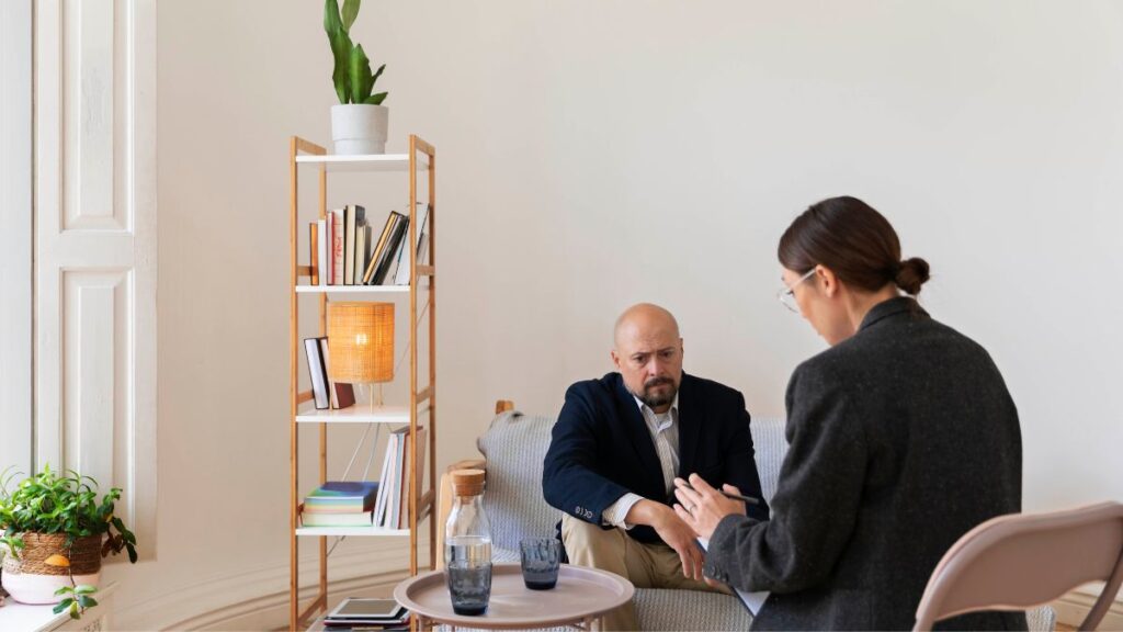 A worried employee receives therapy and counseling from human resources, seeking support during addiction recovery.